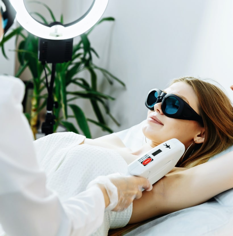 girl receiving laser treatment in office